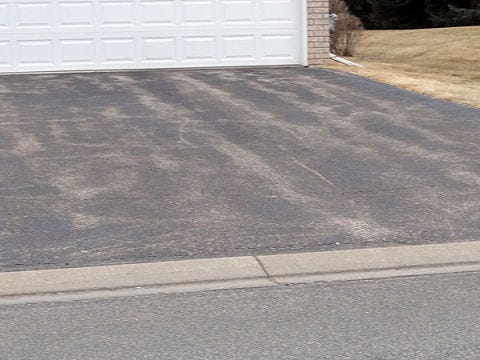 driveway with buckling or wavy asphalt