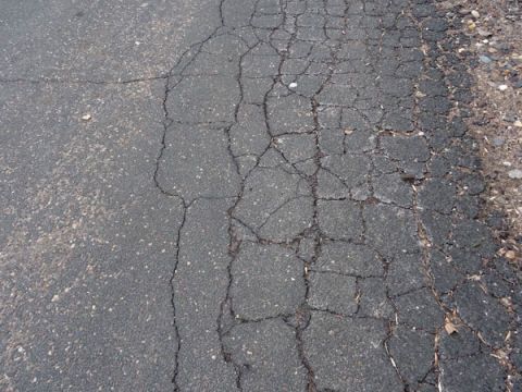 asphalt driveway with crumbling edges
