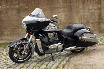 Motorcycle, Automotive design, Automotive tire, Automotive lighting, Rim, Fender, Automotive exterior, Carbon, Vehicle brake, Motorcycle accessories, 