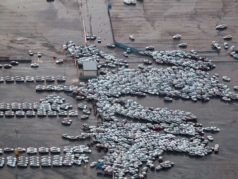 An aerial shot shows vehicles ready for shipping being carried by a tsunami tidal wave at Hitachinaka city in Ibaraki prefecture on March 11, 2011.