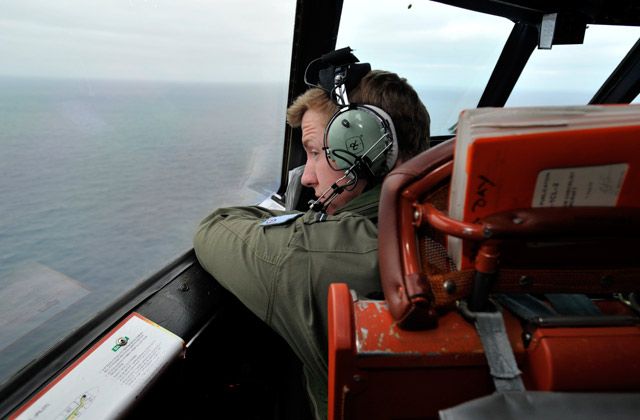 Flying Officer Benjamin Hepworth searches from a Royal Australian Airforce AP-3C Orion from Pearce Airforce Base during a search mission for possible MH370 debris on March 21, 2014 in Perth, Australia.