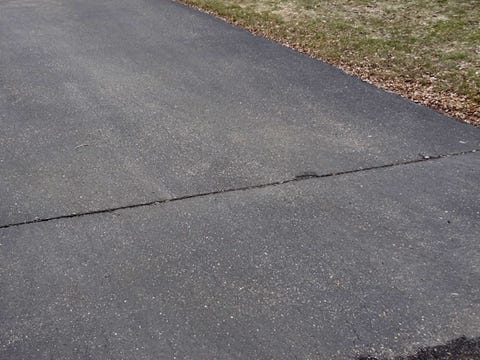 asphalt driveway with linear crack