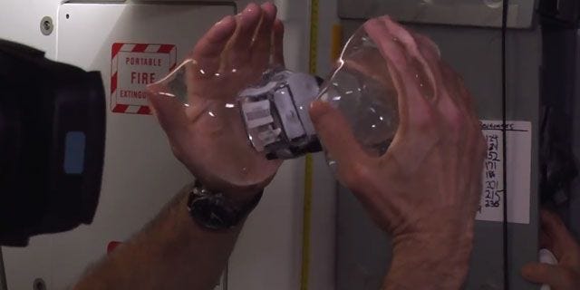 Watch These Astronauts Submerge a GoPro in Space