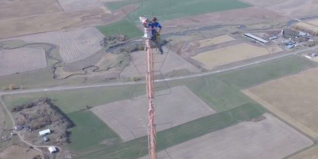 watch-this-man-climb-a-1-500-foot-tower-just-to-change-a-light-bulb