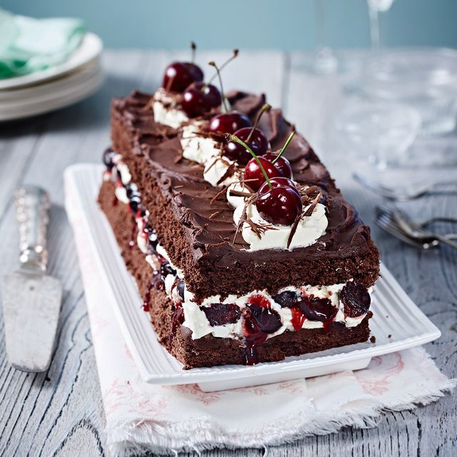 a black forest gateau topped with cherries