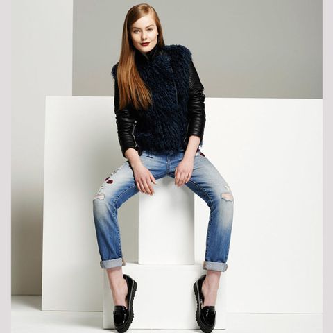 Model wearing jeans and a black gilet