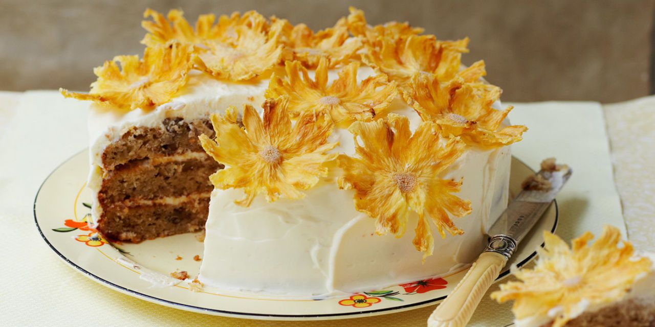 d'lish on port - Spiced pineapple cake covered and filled with cream cheese  icing. Decorated with pineapple flowers, roasted white chocolate and  praline | Facebook