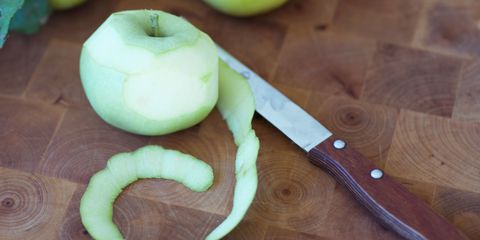 Apple peel on chopping board with knife