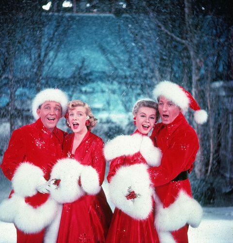 Bing Crosby (1903 - 1977), Rosemary Clooney (1928 - 2002), Vera-Ellen (1921 - 1981), and Danny Kaye (1913 - 1987) sing together, while dressed in fur-trimmed red outfits and standing in front of a stage backrop, in a scene from the film 'White Christmas,' directed by Michael Curtiz, 1954.