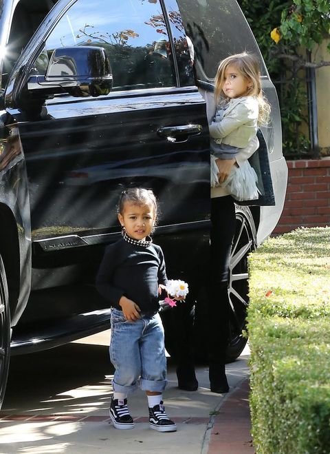 <p>Going rogue for an outing with her cousin P, North rocks a studded choker, black long-sleeve shirt, rolled-up jeans, and high-tops like a boss.</p>