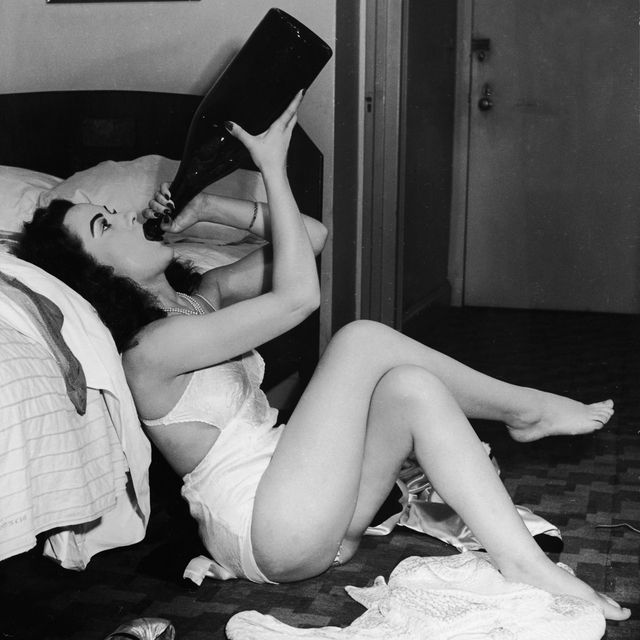retro woman drinks wine in underwear