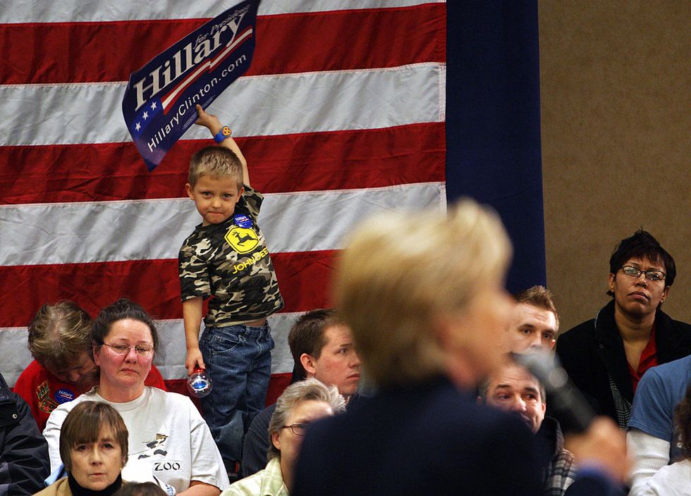 kid with hillary clinton sign