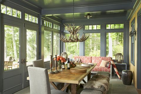 <p>A porch can be a lovely hangout spot way beyond summer. Just be sure its colors feel right no matter the weather. "These dark walls and ceiling provide a cool, shaded refuge in summer and a snug dining room in winter," says Hendricks. Likewise, the sofa's red batik feels lively during hot months, yet inviting when it's cold. "Don't be afraid of mixing decor from all sorts of retailers. I love Restoration Hardware, CB2, and even thrift stories. And The Land of Nod is fun for non-kid things."
</p><p><br>
</p><p><strong data-redactor-tag="strong">Bring the Outside In</strong><br>Surrounded by windows, this room seems like an extension of nature. To play that up, "take an organic approach to the decor, like an antler chandelier (Hampton Bay, $189; <a href="http://www.homedepot.com/p/Hampton-Bay-5-Light-Natural-Antler-Hanging-Chandelier-17195/202188190" target="_blank" data-tracking-id="recirc-text-link">homedepot.com</a>) or a (faux) sheepskin throw," Hendricks suggests. Even adding something as simple as freshly picked flowers and a bowl of fruit helps. <br>
</p><p><br>
</p><p><strong data-redactor-tag="strong">Protect It From the Elements</strong><br>The wood table is sealed to hold up to moisture, while the bluestone floors won't fade from the sunlight. The same goes for all the textiles. The sofa and upholstered seating are made using sturdy outdoor-friendly materials that dry faster than regular fabrics.<br>
</p>