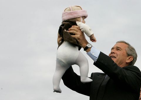 LITITZ, PA - OCTOBER 27:  U.S. President George W. Bush holds up a baby during a campaign rally at Lancaster Airport October 27, 2004 in Lititz, Pennsylvania. Polls show that Bush is in a neck and neck race with his challenger, Democratic presidentail nomminee Sen. John Kerry (D-MA), with less than a week to go before the November 2 election.  (Photo by Mark Wilson/Getty Images).