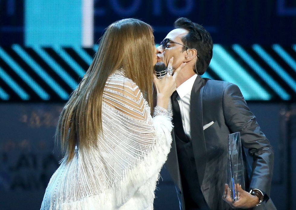 Jennifer Lopez and Marc Anthony kiss on stage at the Latin Grammys