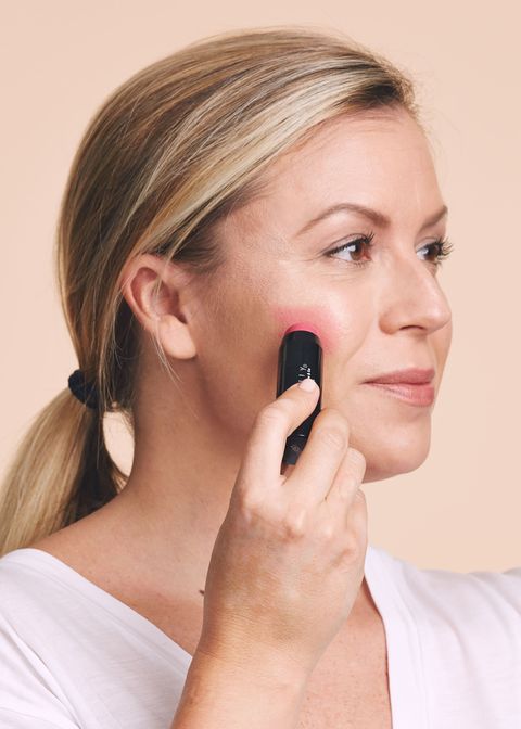 <p>It may seem weird to apply blush before bronzer, but this way, you'll get a hint of rosiness peeking through from underneath. Rub a cream formula in a rosy pink shade on the apples of your cheeks, then buff away the edges with your fingers.&nbsp;</p>