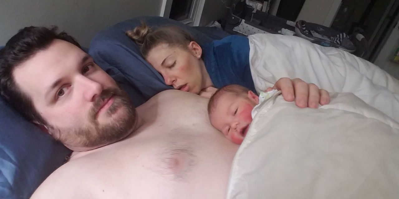 mom and dad sleeping with baby