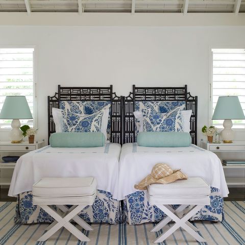 <p>When the color scheme is this pared-down, it gives you license to really play with prints. The secret is so simple: "Vary the scale and location of the prints," advises Braff. For example, the oversize floral pillows on the bed contrast so well with the skinny-striped rug on the floor.</p>