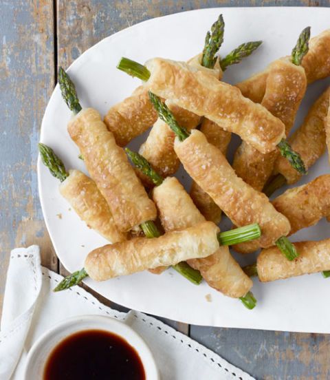 <p>This earthy vegetable meets its delicious match in the form of buttery-good puff pastry—turning an iconic side into an easy appetizer.</p>
<p><strong>Recipe:</strong> <a href="http://www.countryliving.com/recipefinder/pastry-wrapped-asparagus-balsamic-dipping-sauce-recipe-clv0413" target="_blank">Pastry-Wrapped Asparagus with Balsamic Dipping Sauce</a></p>