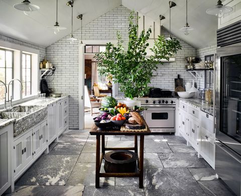 <p>Vaulted ceiling aside, a film-set-worthy kitchen of your own is not out of reach. Just try these ideas.
</p><p><strong data-redactor-tag="strong">1. Layer on the neutrals.</strong> Always sophisticated: crisp whites, cool stainless, and lots of natural materials. For major bang for your buck, focus on subway tiles and a slate floor instead of pricey marble countertops. Then warm up those <a href="http://www.redbookmag.com/home/a41851/clear-out-kitchen-clutter/" target="_blank" data-tracking-id="recirc-text-link">sleek surfaces</a> with a rustic table that serves as a <a href="http://www.redbookmag.com/home/decor/features/g2796/genius-kitchen-island-diys/" target="_blank" data-tracking-id="recirc-text-link">kitchen island</a> and wooden boards and bowls.
</p><p><strong data-redactor-tag="strong">2. Hang stylish lighting.&nbsp;</strong><span>Think of fixtures as the statement earrings of a monochromatic room — there to <a href="http://www.redbookmag.com/home/g2716/16-chic-accessories-that-glam-up-your-kitchen-immediately/" target="_blank" data-tracking-id="recirc-text-link">bring the sparkle</a> and pull the whole look together. The more pendants you use, the bigger their impact.</span></p><p><strong data-redactor-tag="strong">3. Liven it up with greenery.&nbsp;</strong><span>You don't need to have a florist on call either. Head out to the yard and <a href="http://www.redbookmag.com/home/news/g2979/best-plants-for-a-garden/" target="_blank" data-tracking-id="recirc-text-link">clip a few branches</a> to drop into a vase. It'll remind you of the lush arrangements you'd see in a high-end hotel lobby.</span></p>