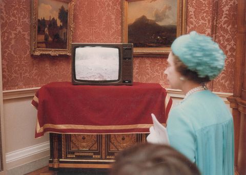 <p>Queen Elizabeth watches the crowds outside Buckingham Palace on TV.</p>