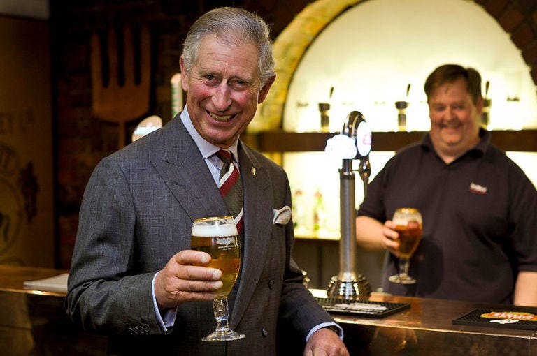 prince charles drinking a pint of beer