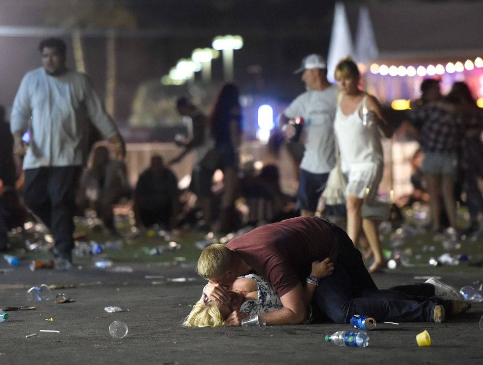 <p>A man and woman lie on the ground in the aftermath of the shooting. </p>