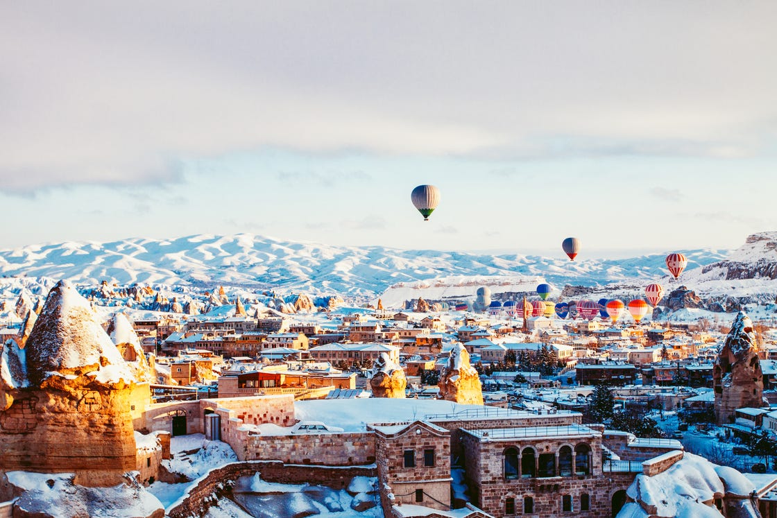 hot air balloon, sky, winter, town, snow, city, urban area, human settlement, hot air ballooning, cloud,