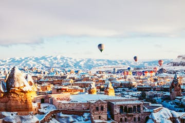 hot air balloon, sky, winter, town, snow, city, urban area, human settlement, hot air ballooning, cloud,