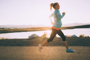 pregnant woman running with support band