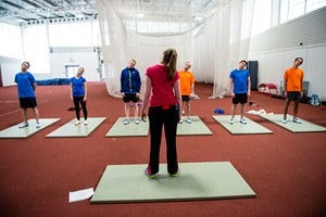 Social group, Standing, Flooring, Room, Physical fitness, Line, Floor, Electric blue, Active pants, Hall, 