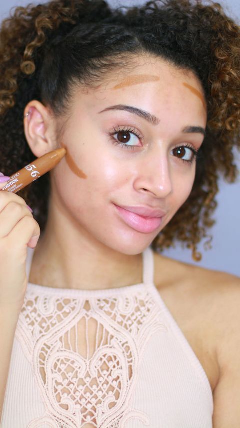 <p>Use your contour stick on your bare face <em>before</em> any foundation, focusing on the area under your cheekbones and along the perimeter of your forehead. Next, blend out the cream with a firm makeup brush or sponge to avoid harsh lines.</p>
