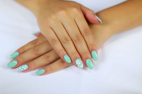 <p>I love this design because it's super easy to achieve, which is comforting for beginners who are hesitant to decorate their own nails. Start off by applying a single coat of polish in your favorite color, then let it dry for a few minutes. Next, take a nail art tool, dip it into a contrasting shade and create a series of evenly spaced dots. Simple, right? </p>
