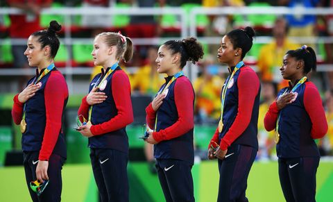 Red, Uniform, Athlete, Team, Active pants, Playing sports, Crew, Medal, 