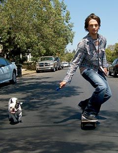 guy on a skateboard with his dog