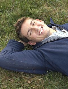 cute-guy-in-grass-squinting