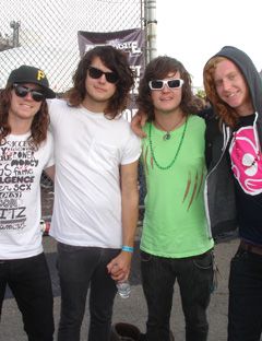 four young males in teeshirts and sunglasses