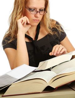 girl with a stack of open books