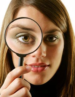 girl holding magnifying glass