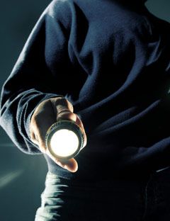 man shining a flashlight