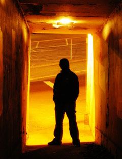 man standing in a parking lot tunnel