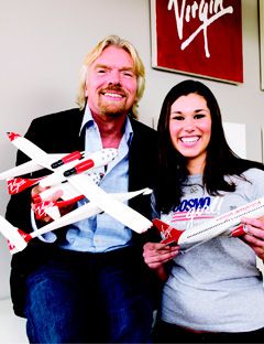 richard branson holding toy planes with a girl