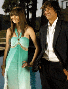 girl in teal halter gown and boy in casual suit