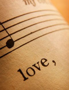 close up of sheet music with the word love