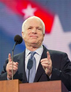 john mccain in front of mic pointing with both hands