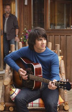 Joe Jonas strums away on his guitar on the set of Camp Rock