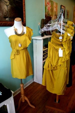 Yellow, Textile, Fashion, Clothes hanger, Home accessories, One-piece garment, Mannequin, Fashion design, Vintage clothing, Day dress, 