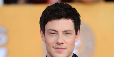 cory monteith from glee in a suit