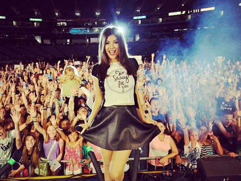 victoria justice takes a pic on stage