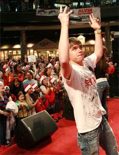 jesse mccartney on stage with hands in the air